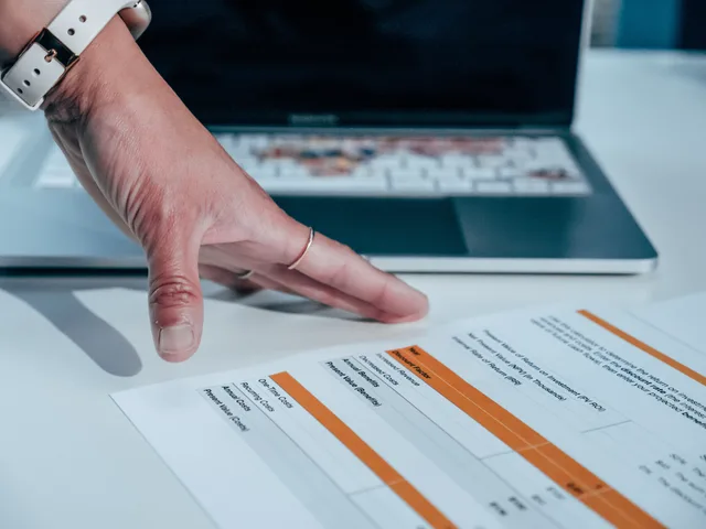 Close-up of a hand reviewing a financial report on a laptop, indicating focus on business analysis. Why your affiliate marketing reporting dashboard disagrees with finance