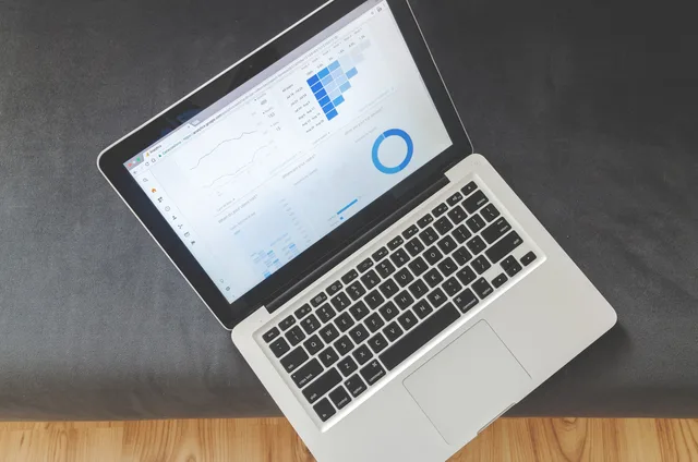 Overhead view of a laptop showing data visualizations and charts on its screen. Seven affiliate marketing skills that England teams will need as the forecast shifts