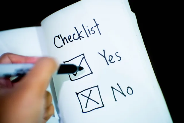 A notebook featuring a checklist with a marked 'Yes' box, captured in a close-up shot. Assessing affiliate marketing vendors: a UK checklist